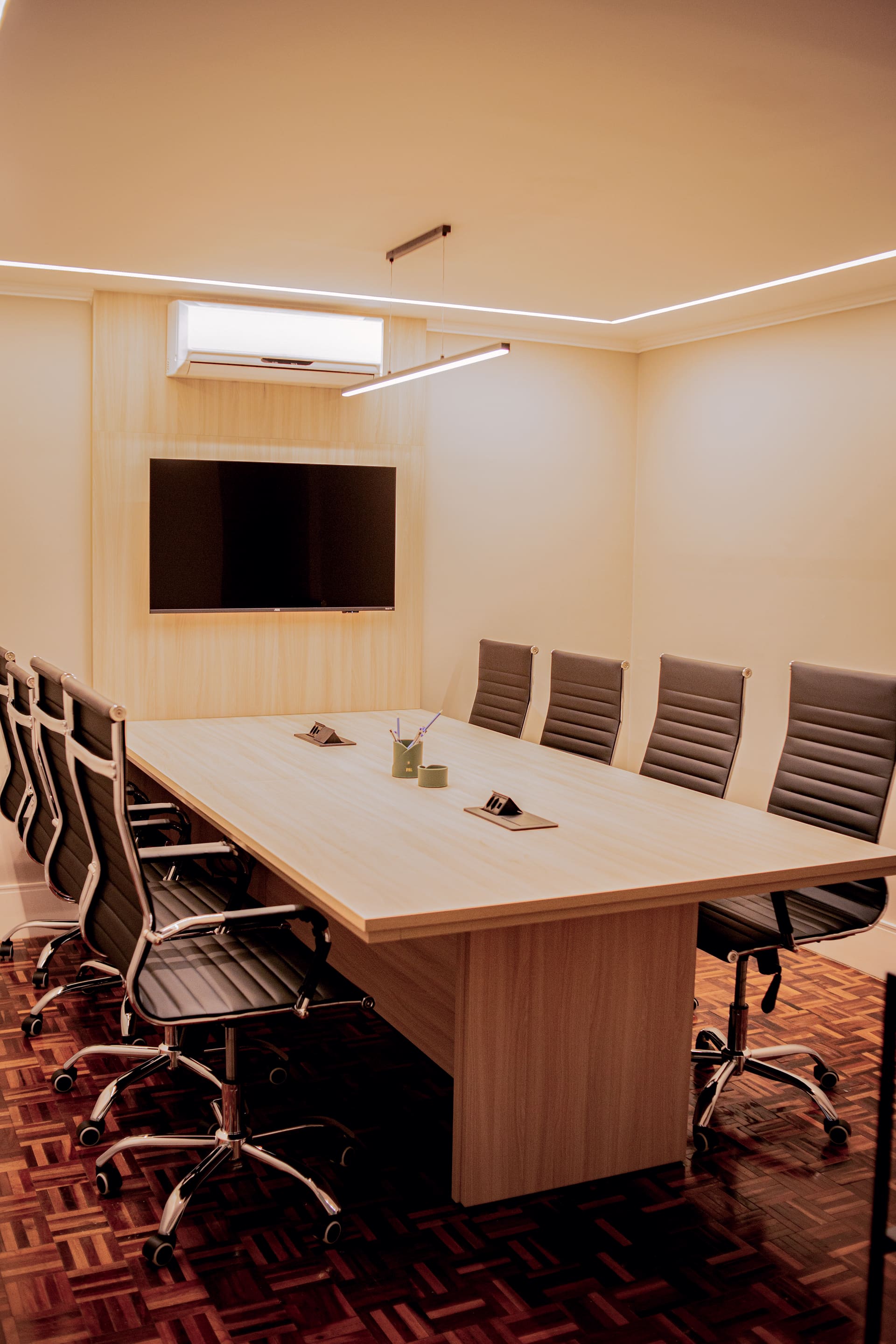 Work room at the firm, with a white desk and caramel leather chair